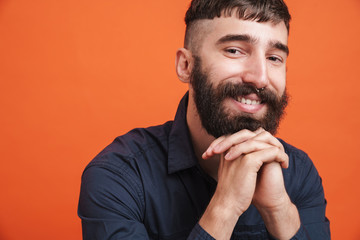 Image of unshaven stylish man with nose jewelry smiling at camera