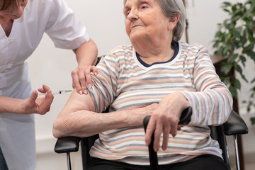 Senior woman getting an injection