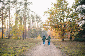 Verliebtes Paar in Winterjacken beim Spaziergang Wandern im Wald Herbst Sonnenuntergang
