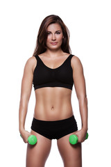 Fototapeta premium Fitness girl with dumbbells on a white background