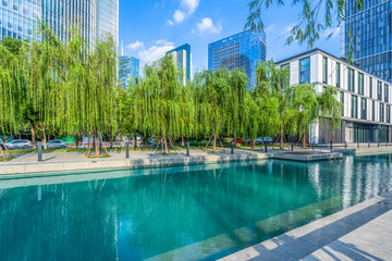 modern office buildings at riverbank under blue sky in china