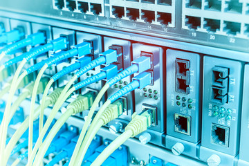 Fiber Optic cables connected to an optic ports and Network cables connected to ethernet ports