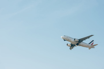 Low angle view of jet plane taking off in blue sky