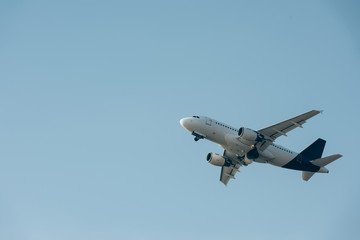Fototapeta na wymiar Low angle view of jet plane in blue sky