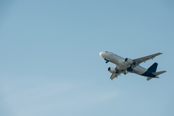 Fototapeta na wymiar Flight departure of airplane in clear sky with copy space