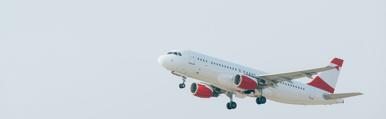 Departure of airplane with cloudy sky at background, panoramic shot