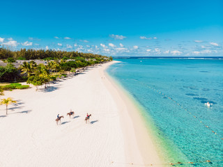 Luxury tropical beach in Mauritius. Holiday beach with palms and ocean. Aerial view