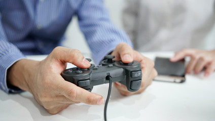Happy couple playing video games with joysticks