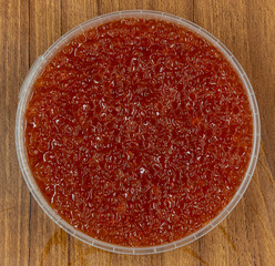 Red caviar close up macro on wood table background