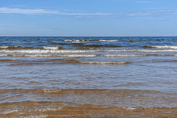 sea surf against a bright blue sky