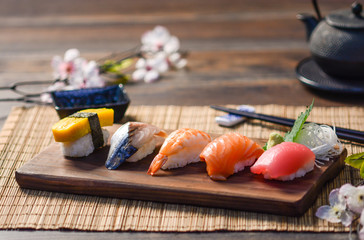 Mix sushi on wood dish, tuna, salmon, sea bass, sweet egg, shrimp sushi, Japanese food