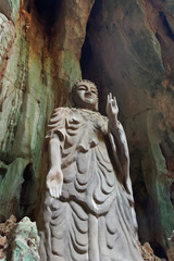 Fototapeta na wymiar Low angle view of stone Buddha in a cave