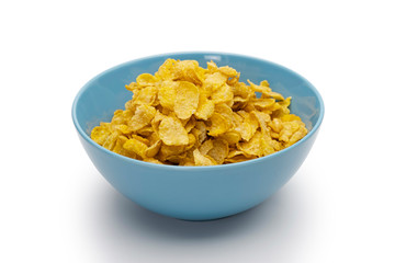Golden cornflakes in the blue bowl isolated on white background