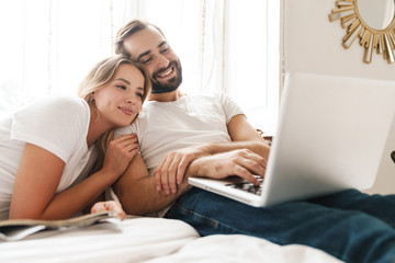 Beautiful young couple relaxing on bed