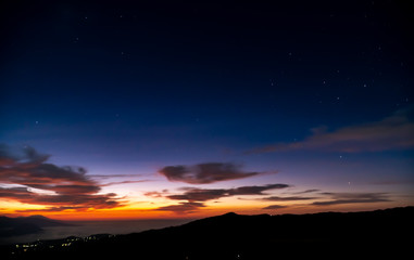 Fototapeta na wymiar Starry Sky Sunrise with low lying clouds from Mount Bromo with a view of Mount Argopuro and G. Lemongan, Volcanoes in Java, Indonesia