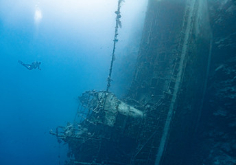 Scubae diver and shipwreck at coral reef, Solomon Islands