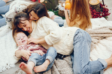 Beautiful mother with children. Family at home. People in a Christmas decorations.