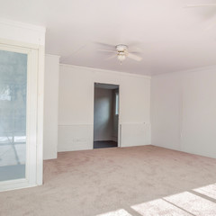Square Bedroom with lots of lighting coming in from the windows