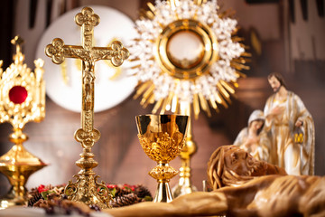 Catholic concept background.  The Cross, monstrance, Jesus figure, Holy Bible and golden chalice on...