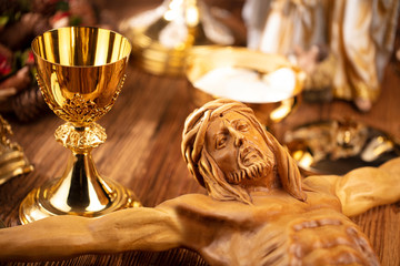 Catholic concept background.  The Cross, monstrance, Jesus figure, Holy Bible and golden chalice on...