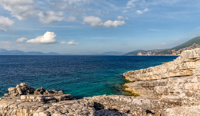 Natural seascape in the Greece. Seascape with rocky beach, turquoise water and colorful sky. Amazing nature Landscape.