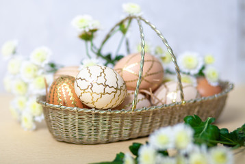 Easter eggs in a nest with a feather of a bird. Zero waste concept.