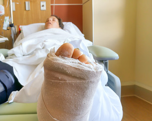 Woman in hospital with bilateral ankle fractures sleeping after surgery.