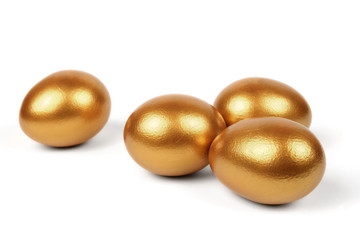 Golden eggs on a white background