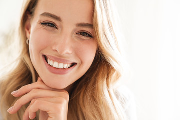 Smiling young beautiful blonde woman wearing t-shirt