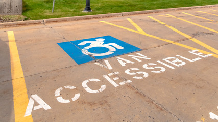 Pano Handicapped parking lot with painted handicap symbol and Van Accessible sign