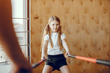 Beautiful girl in the gym. Child performs exercises.