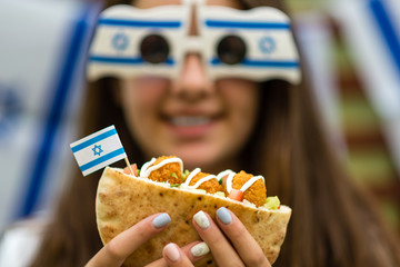 Israeli girl holding pita with falafel