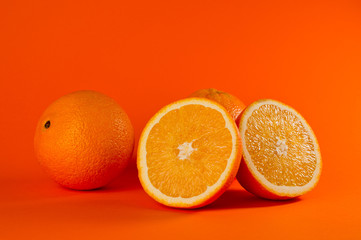 Fresh and juicy orange photographed on a background of orange