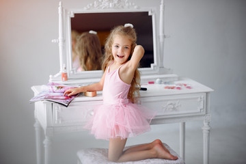 Obraz premium Little lady in a room. Child in a pink dress. Little girl with curlers on her head.