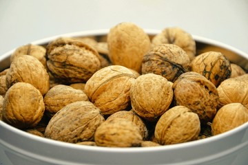 Whole walnuts in a bowl. Closeup