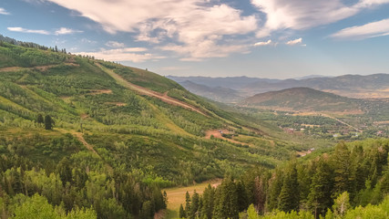 Pano Hiking trails and green trees on a ski resort mountain in Park City in summer