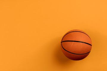 Ball for basket ball on an orange background