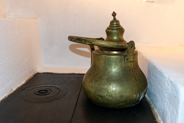 Old romanian kettle stand on a stove top. historical monument archaeological
