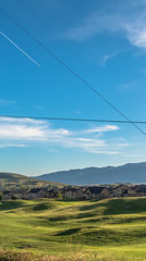Vertical frame Fence with scenic view of golf course houses and mountain on a sunny day