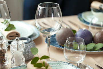 Table setting set with candles and plant branches