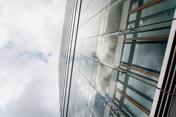 Dramatic view of skyscrapers against cloudy sky. View of the skyscraper from below