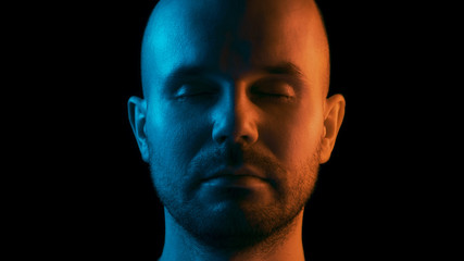 A man with closed eyes is meditating. Dual color theme. Black background