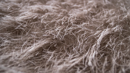 Beige fluffy threads for knitting, close-up.