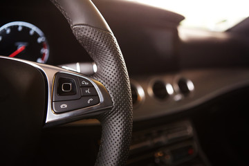 Control buttons on the steering wheel of a car - Powered by Adobe