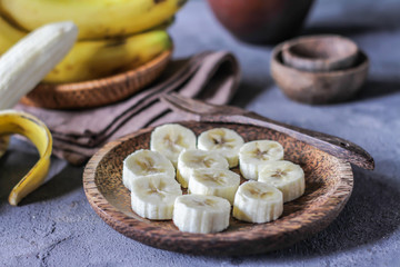 Photo of whole and sliced bananas on retro background. Healthy breakfast. Yellow fruit. Tropical fruit. Ready to eat. 