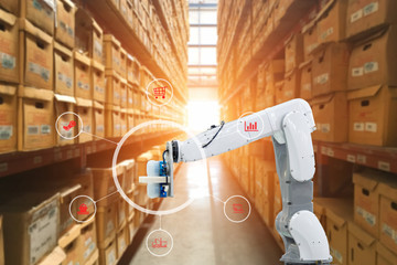 Automatic robot mechanical arm is working in temporary storage in a distribution warehouse.