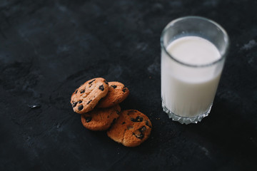 Glass with fresh milk and chocolate chips cookies.  Oatmeal cookies  and glass of milk for breakfast. Healthy good morning