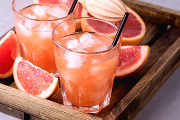 Two Glasses of Tasty Grapefruit Cold Drink or Cocktail Refreshment Beverage Gray Background Cold Grapefruit Juice Copy Space