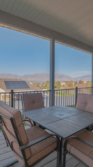 Vertical Outdoor dining furniture on a covered patio