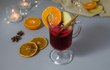 Glintwein in glassware and set for making a drink on a blue surface.